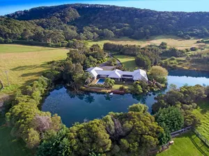 Image of Mystique Country House-Stunning house beside a lake and mountain backdrop.