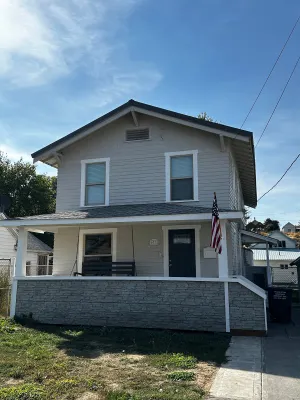 Image of Cheerful home with front porch swing.