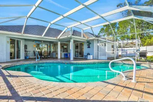 Image of Contemporary coastal escape with heated pool, fenced yard, & outdoor dining