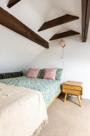 Image of En-suite with double bed on mezzanine and desk in family home