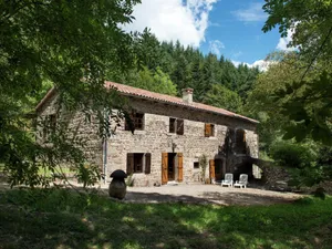 Image of Beautiful stone farmhouse in mountain forest setting