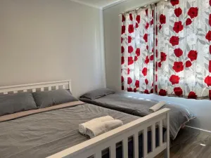 Image of 2 Double Beds, 1 Single Bed, 1 Double Sofa Bed in a small 1 bedroom and 1 lounge Studio No Kitchen Only fridge, microwave
