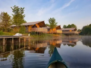 Image of Tents with kitchen and bathroom near a pond