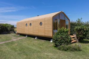 Image of Tiny Wrap-around House on the Edge of Beach
