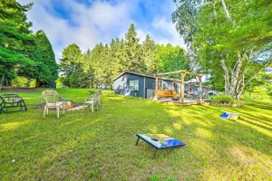 Image of Riverfront Home with Dock about 6 Mi to Cheboygan!
