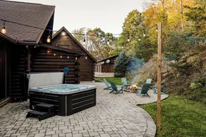 Image of Log Cabin with living room fireplace and hot tub