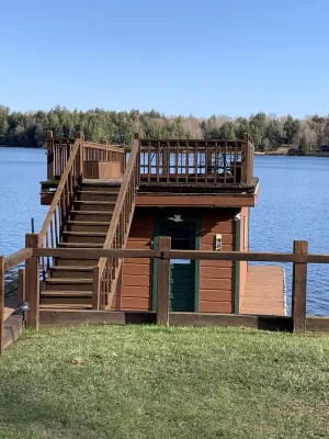Image of Waterfront Camp with Boathouse - Wifi, kayaks, canoe and sandy bottom out front.