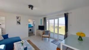 Image of Large patio doors from the lounge lead to lawned area, ideal for watching the sun set over St. Ives
