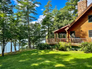 Image of Waterfront log cabin nestled in the woods providing unparalleled privacy
