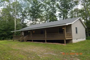 Image of 3 Bedroom home with rear deck and covered front porch.