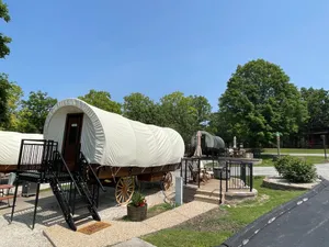 Image of California Trail Wagon includes 1 king bed, bathroom w\/ shower, heat & a\/c, smart tv, wi-fi, microwa