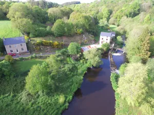 Image of Authentic mill with feet in water (near the sea)