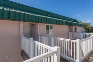 Image of Boardwalk access, a swimming pool, volleyball area, large grass lawn, outdoor grills