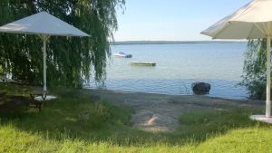 Image of Seagull house, beach, bathing jetty, boat mooring on Lake Plau