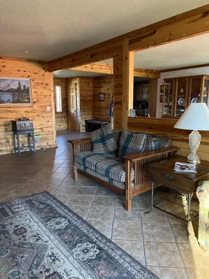 Image of Cozy Lakeshore Family retreat, deck with propane grill spacious rustic home.