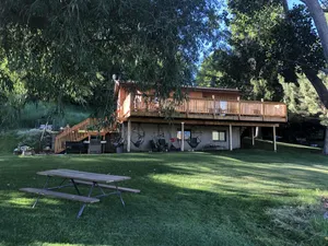 Image of A wonderful, secluded 2 story cabin, deck, fire pit, stocked pond for fishing.