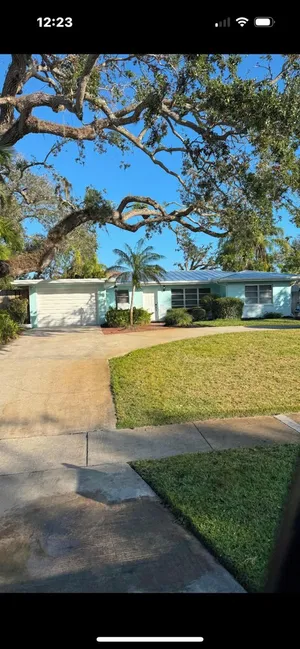 Image of A tropical secluded retro bungalow with terrazzo flooring & a heated pool.