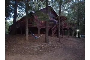 Image of 2 story log cabin with lake view. Located in front of Raymond Gary state park.