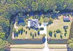 Image of Paradise Palms surrounded by man made mote in Manning, South Carolina!