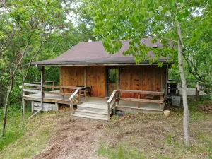 Image of Quaint cabin overlooking the creek below and wetlands in the valley basin.