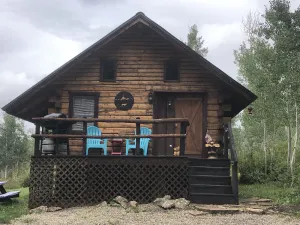 Image of Wolf Den Cabin is cozy and rustic that overlooks the beautiful aspens trees.