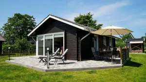 Image of Charming wooden cottage \"Schmidt's Huus\" in Swedish style offers you high-quality furnishings as well as a well-tended garden with a large terrace for a vacation with the whole family or in intimate togetherness