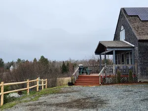 Image of Beautiful and modern cape style cottage nested along the Jordan Tidal River.