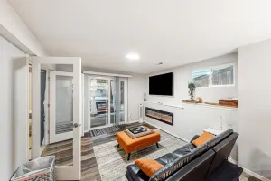 Image of Modern lower-level getaway with a fireplace, inviting patio & washer\/dryer