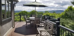 Image of Adirondack cabin w\/ large deck & outdoor grill