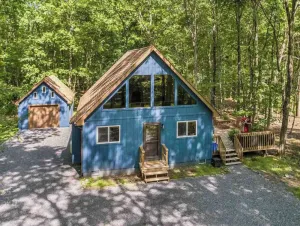 Image of modern a-frame cabin with lake access & hot tub