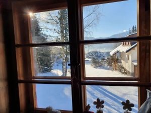 Image of cozy house in a sunny place with a fantastic mountain panorama