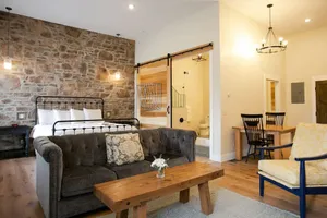 Image of Unique Rustic Suite with Jacuzzi Tub, Kitchen, Fireplace, and Living Room