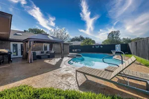 Image of Master bedroom overlooking heated pool & hot tub