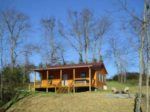 Image of A cozy new cabin in rural setting with a hot tub on porch. Beautiful rural view.