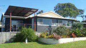 Image of Old style beach house with views of the river joining the ocean