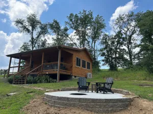 Image of A cozy new cabin in rural setting with a hot tub on porch. Beautiful rural view.