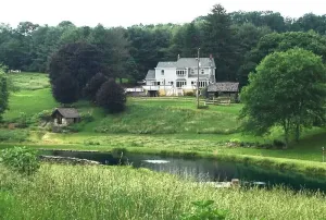 Image of Modern farmhouse located on 53 acres of manicured rolling hills.
