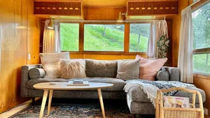 Image of The Spartan is a fun 1950's vintage trailer under oak trees overlooking a 1 acre organic farm!