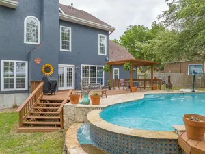 Image of Come enjoy our peaceful house oasis that features a backyard patio with a pool!
