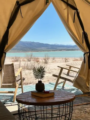 Image of Delightful wall tent on sandy beach at waters edge
