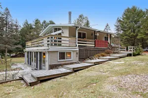 Image of Lakefront Home with a Private Dock, Deck, Fireplace, Spacious Yard, & Playset