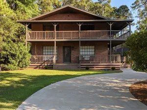 Image of Fishers Foxhole - two story home with wrap around deck and lake access.