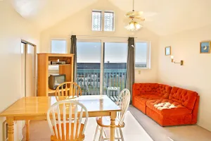 Image of 1BR beachfront condo with kitchen & sea-view balcony.