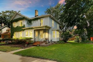 Image of Historic house on tree lined red brick street of historic homes.