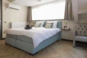 Image of Newly renovated 1920 building with queen hotel bed, patio, and shared kitchen.
