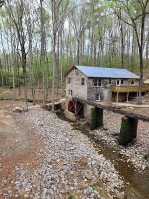 Image of Historic Cabin in a natural setting with waterfalls and covered bridge