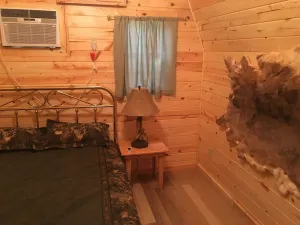 Image of Small one room cabins with no bathrooms hot tub and covered picnic tables.