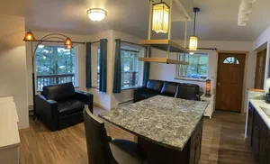 Image of The Bear Den. Water view, eagle view, deer and  black bear, cover deck and BBQ.