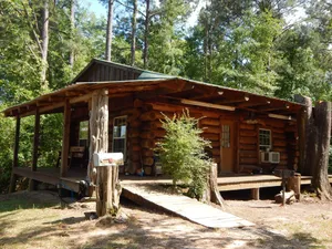 Image of Rustic Log Cabin with fishing.