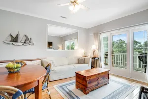 Image of 2nd-floor retreat with screened porch, shared pool, WiFi, central AC & elevator